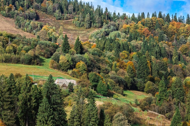 Paesaggio rurale con una vecchia casa in collina in montagna.