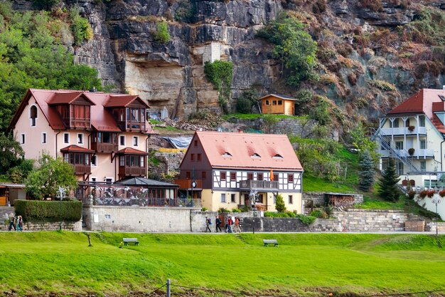 Paesaggio rurale la casa su uno sfondo di verdi colline e un sacco di gente