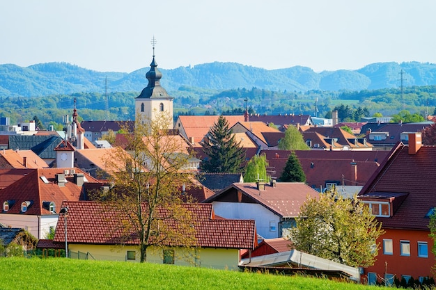 Paesaggio urbano con i tetti delle case e la Chiesa di Nostra Signora dei Sette Dolori nel centro storico di Slovenska Bistrica vicino a Maribor in Slovenia. Stiria meridionale in Slovenija. Campanile della cattedrale nella città slovena.