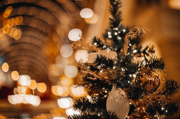 Palla di Natale magica e lucida dorata e decorazioni appese all'albero di Natale Vacanze invernali
