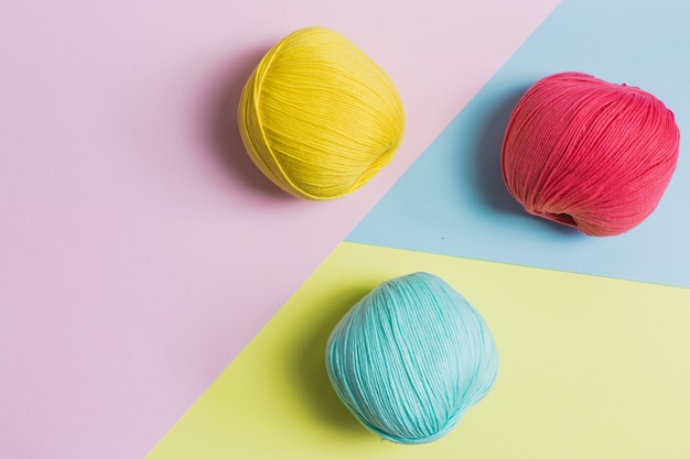 Palle di lana tonica pastello su sfondo colorato