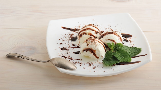 Palline di gelato con cioccolato e foglie di menta con dessert