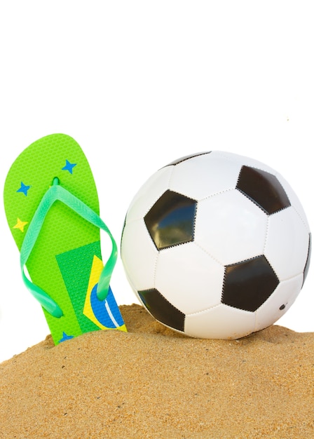 Pallone da calcio in sabbia con flip flop nei colori brasilia isolati sul bordo bianco del fondo