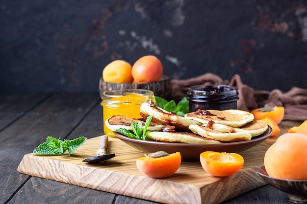 Pancakes con marmellata, albicocca e menta. Delizioso dessert per colazione.