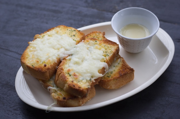 Pane all&#39;aglio di formaggio in piatto di ceramica.