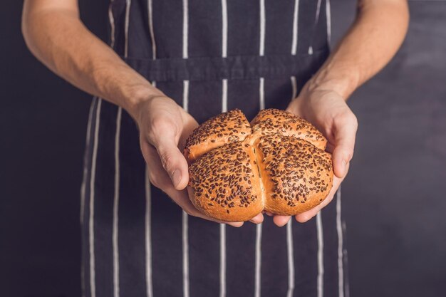 Pane con semi di lino nelle mani di un fornaio.