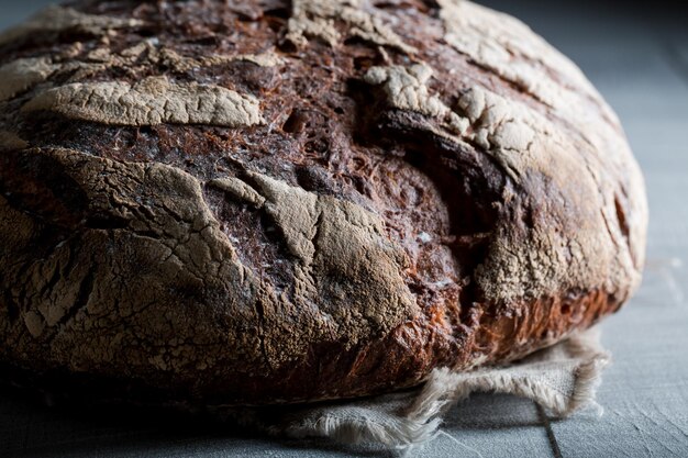 Pane fatto in casa e fresco con diversi grani su tavola scura