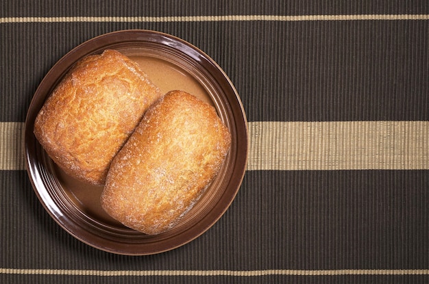 Pane fresco della ciabatta nel piatto sulla vista superiore del tovagliolo scuro Spazio per testo