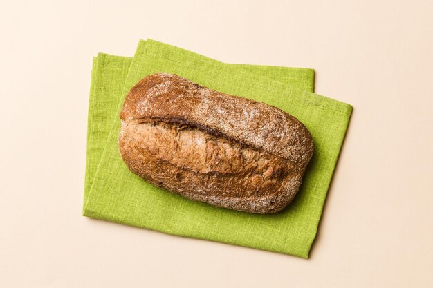 Pane fresco fatto in casa con pane integrale sul tovagliolo su sfondo rustico vista dall'alto del pane fresco