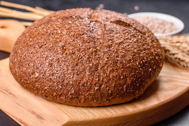 Pane integrale appena sfornato con spighe e chicchi di grano