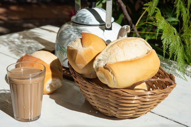 pane, un bricco di caffè in una tazza di latte americano