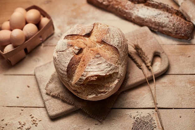 Panetteria dorata rustica pagnotte croccanti di pane e su sfondo di legno Natura morta catturata dall'alto vista dall'alto piatta