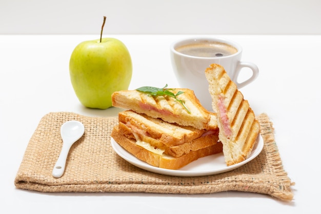 Panino al formaggio grigliato fatto in casa per colazione con una tazza di caffè