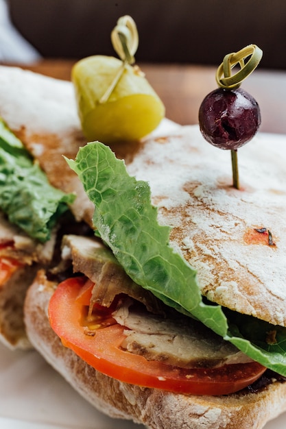 Panino di pollo alla griglia con pane, pomodoro e lattuga servito con insalata di barbabietole