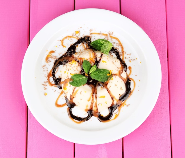 Panna cotta con cioccolato e salsa al caramello su fondo di legno colorato