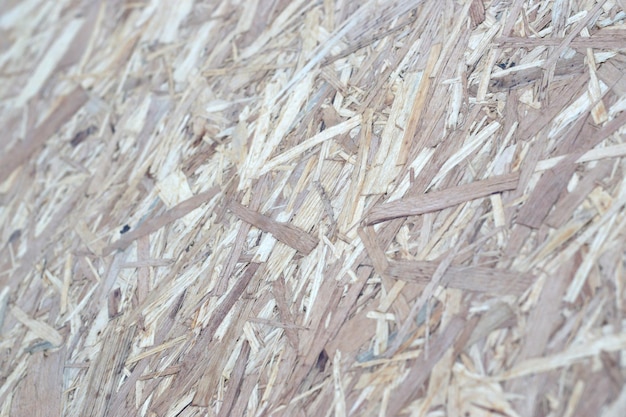 Pannelli OSB realizzati con trucioli di legno marrone levigati su uno sfondo di legno Vista dall'alto della superficie di sfondo dell'impiallacciatura di legno OSB