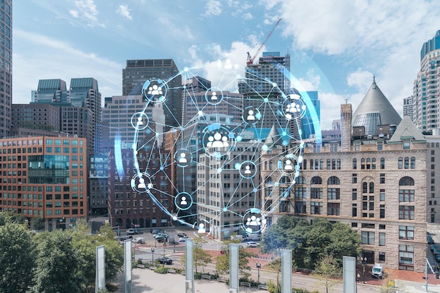 Panorama di vista della città del centro finanziario di Boston dall'area del porto durante il giorno Massachusetts Incandescente Icone dei social media Il concetto di networking e stabilire nuove connessioni tra le persone