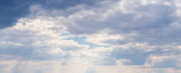 Panorami del cielo densamente ricoperti di nuvole bianche e grigie al tramonto