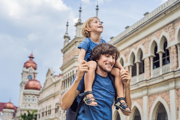 Papà e figlio sullo sfondo del Sultan Abdul Samad Building a Kuala Lumpur in Malesia Viaggiare con il concetto di bambini