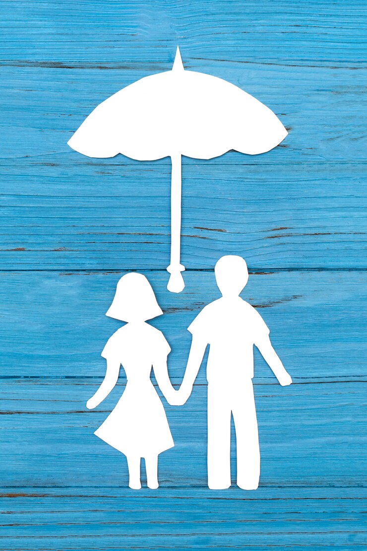 Paper silhouette of man and woman holding hands under umbrella