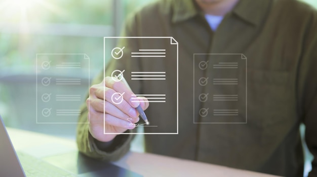 Paperless workplace contract concept Businessman signs electronic documents on digital documents on virtual laptop screen using a pen Online business contract Electronic signature esigning