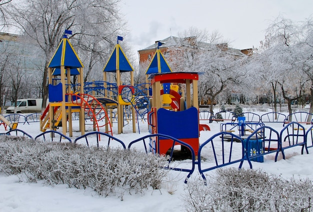 Parco giochi vuoto per bambini nel parco cittadino in inverno