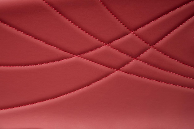 Parte dei dettagli del sedile del poggiatesta dell'auto in pelle Seggiolino per auto Sloseup in pelle traforata rossa Texture della pelle