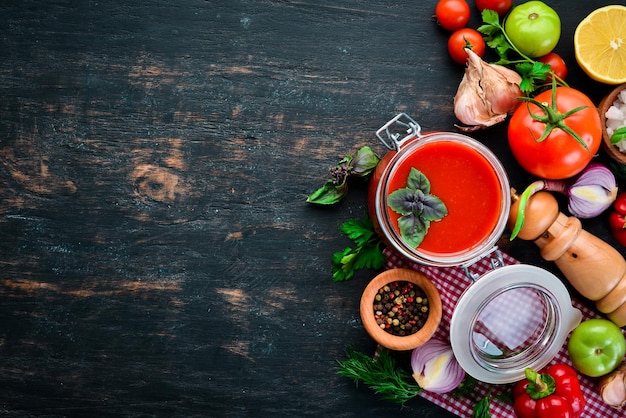 Passata di pomodoro Ketchup con verdure fatte in casa Vista dall'alto su sfondo nero Spazio libero per il testo