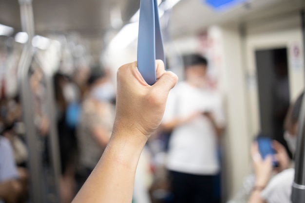 Passeggeri che tengono il corrimano sotterraneo a Bangkok Tailandia