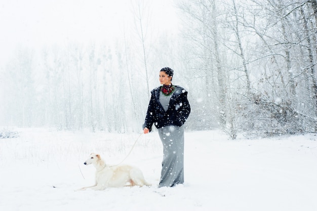 Passeggiata invernale in una tempesta di neve con un cane