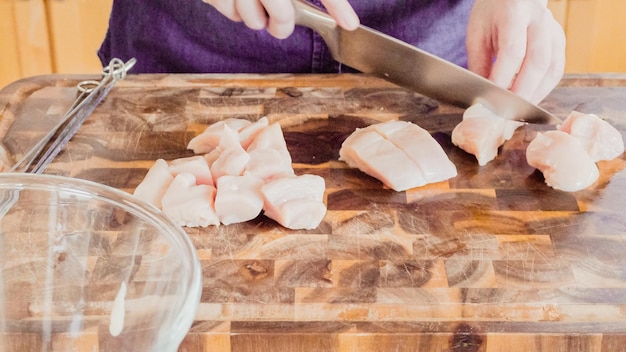 Passo dopo passo. Affettare il pollo biologico per spiedini di pollo.