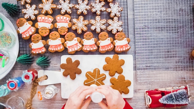 Passo dopo passo. Disposizione piatta. Decorare i biscotti di pan di zenzero con la ghiaccia reale.