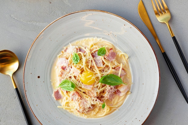 Pasta alla carbonara con pancetta e panna servita sul piatto da vicino