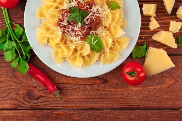 Pasta con carne, salsa di pomodoro e verdure sul tavolo