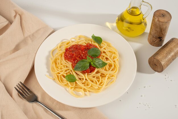 Pasta con pomodori e basilico su uno sfondo bianco