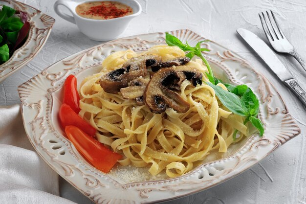 Pasta Fettuccine Bolognese con funghi e verdure sul piatto bianco. Concetto di menu.