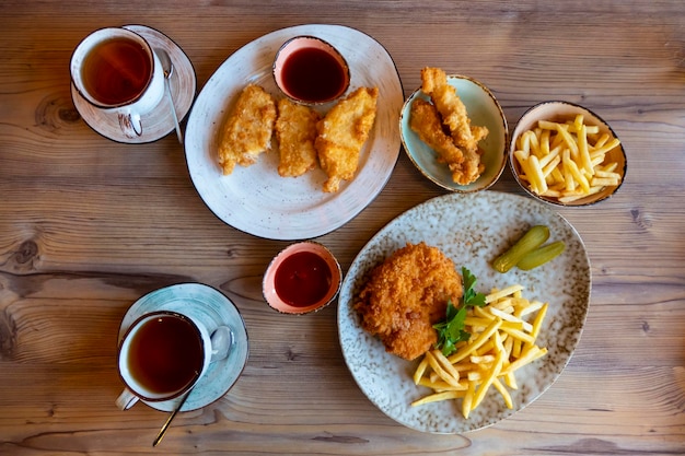 Patate fritte con ketchup su fondo di legno