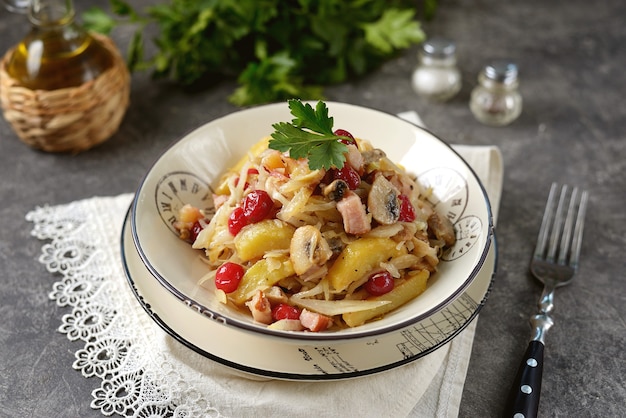 Patate in umido con carne affumicata, cavolo cappuccio, funghi e mirtilli rossi