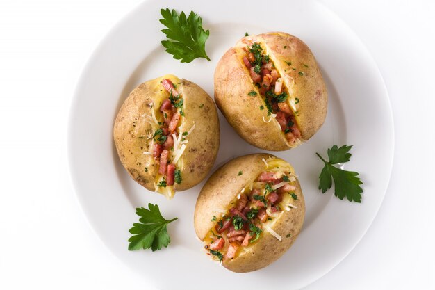 Patate ripiene con pancetta e formaggio sul piatto isolato, vista dall'alto