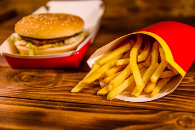 Patatine fritte e hamburger sulla tavola di legno