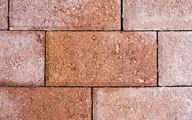 Pavimento in pietra blocco marrone all'aperto pattern e sfondo senza soluzione di continuità, vista dall'alto del fondo delle piastrelle del pavimento