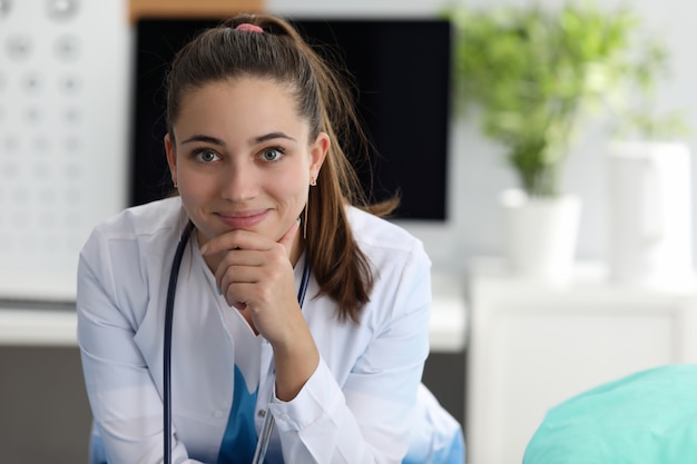 Pediatra attraente sorridente sul lavoro