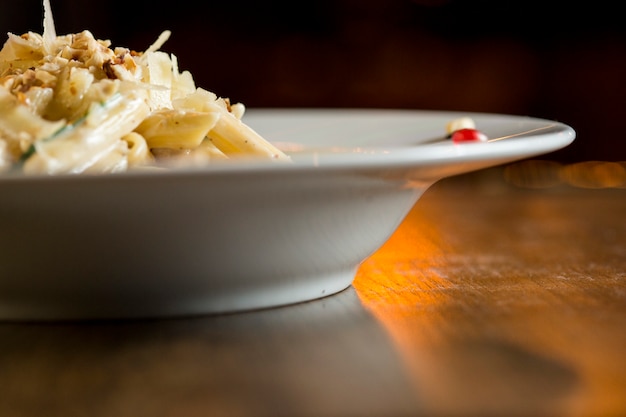 Penne con pollo, spinaci e nocciole in salsa di parmigiano