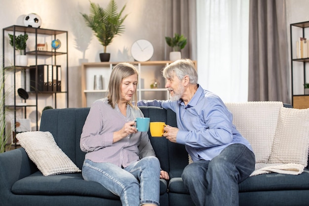 Pensionati spensierati che si godono il caffè e parlano a casa