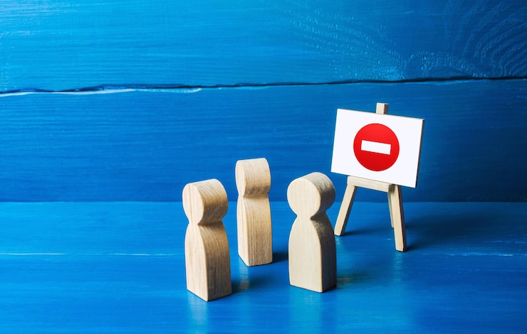 Photo people look at the easel with no stop entry symbol prohibition of actions and operations