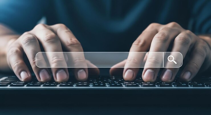 Person Typing on a Keyboard with a Search Bar Overlay