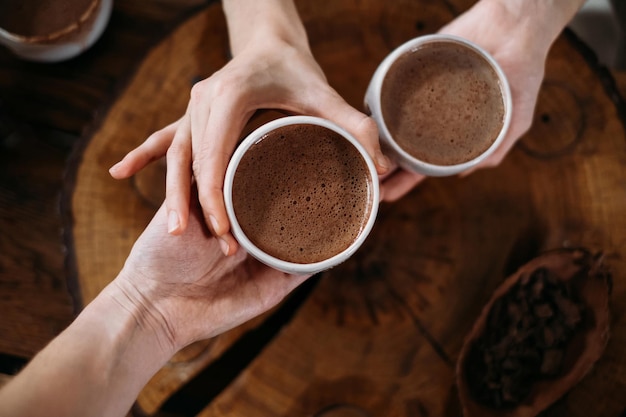 Persona che dà cacao cerimoniale in tazza di bevanda al cioccolato vista dall'alto