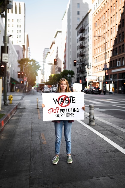 Persona che protesta con il cartello in città per la giornata mondiale dell'ambiente