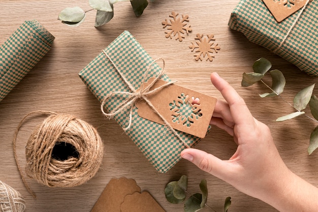 Persona con un regalo di Natale avvolto in un pacchetto festivo