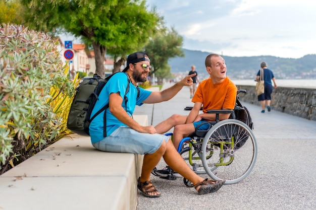 Persona disabile in sedia a rotelle che si diverte con gli amici nelle vacanze estive
